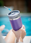 portable bluetooth speaker by the pool on a purple yeti 20oz tumbler